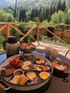 a table with a breakfast of eggs and bread at Eywa House in Kamenskoye Plato