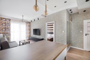 a room with a kitchen and a living room at City View Tower in Poznań