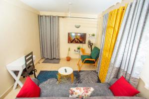 un soggiorno con divano e tavolo di Tom Mboya Estate - Fast WI-FI, Netflix and Parking 1Br Apartment in Kisumu Town a Kisumu
