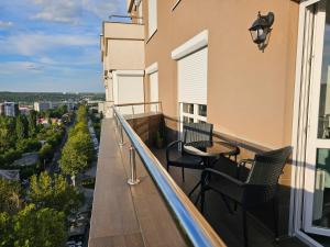 a balcony with chairs and a table on a building at Apartment Dendrarium Residence in Chişinău