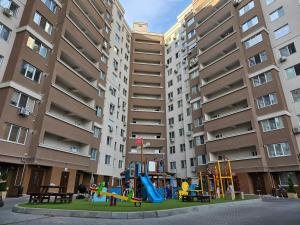a playground in front of a apartment building at Apartment Dendrarium Residence in Chişinău