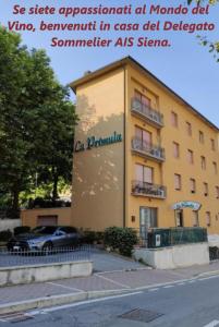 a building with a car parked in front of it at Albergo La Primula in Chianciano Terme