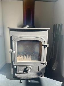 a wood stove with a chimney on top of it at Charming 3BD House wPrivate Garden - Bristol in Bristol