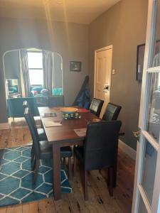 a dining room with a wooden table and chairs at Charming 3BD House wPrivate Garden - Bristol in Bristol