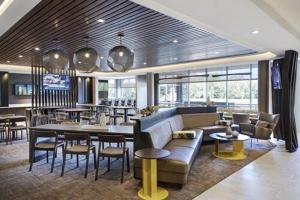 a lobby with a couch and tables and chairs at SpringHill Suites by Marriott Philadelphia West Chester/Exton in Exton