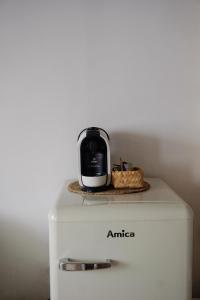 a microwave sitting on top of a white refrigerator at City Hotel Hunsrücker Hof in Boppard