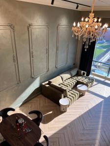 克萊佩達的住宿－ALL - Amberstone Lux Loft，客厅配有吊灯、沙发和桌子