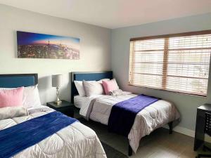 a bedroom with two beds and a window at GREAT LOCATION Downtown/Airport/South Beach in Miami