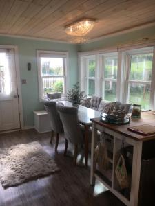 a living room with a dining room table and chairs at Historic 1850 Log Cabin in Westminster