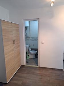 an open door to a bathroom with a toilet at Apartments Neyla in Sarajevo