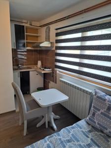a small kitchen with a white table in a room at Apartments Neyla in Sarajevo +26 photos