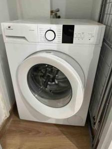 uma máquina de lavar roupa branca num canto de um quarto em 2- Charmant 3 pièces en plein cœur de Beziers em Béziers