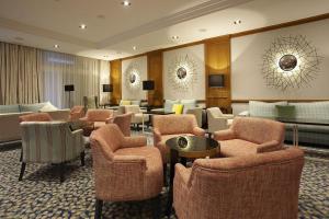 a hotel lobby with chairs and tables at Grupotel Parc Natural & Spa in Playa de Muro
