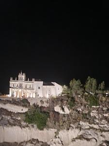 a large white building on top of a cliff at Casa vacanza in Zungri
