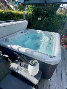 a bath tub sitting on top of a wooden deck at Ferienwohnung Schlossblick - 4 Sterne Sauna Pool Whirlpool privat in Braunfels