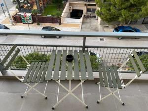 a bench sitting on top of a balcony at Glyfada apartment near the Center in Athens