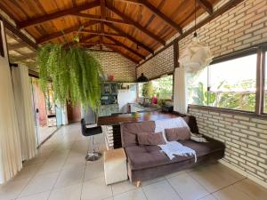 ein Wohnzimmer mit einem Sofa und einem Tisch in der Unterkunft Guest House Jardim Botânico Brasília in Brasilia