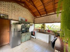 a kitchen with a stainless steel refrigerator in a room at Guest House Jardim Botânico Brasília in Brasilia
