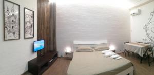 a bedroom with a bed and a television in it at Gli Iblei di Montalbano in Ragusa