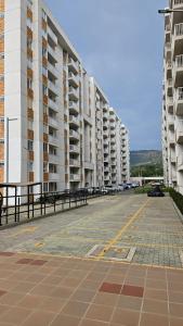 a row of apartment buildings in a parking lot at APARTAMENTO EN VILLETA in Villeta