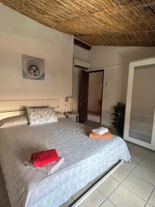 a bedroom with a bed with two pillows on it at El Raval d'Or, casa de 1900 in Busot