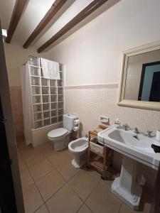 a bathroom with a toilet and a sink at El Raval d'Or, casa de 1900 in Busot