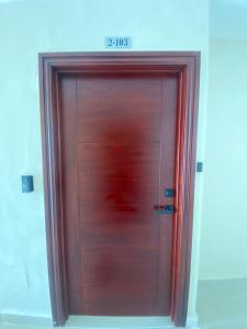 a wooden door with a sign on top of it at Oasis Punta Cana Apartments 3 in Punta Cana