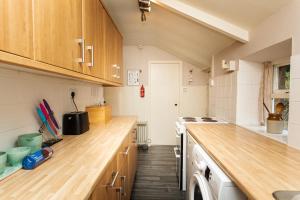 a kitchen with wooden counter tops and wooden cabinets at Bilton Farm Cottage No2 in Alnmouth