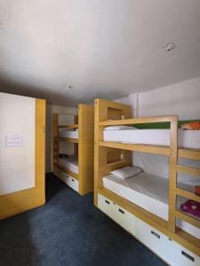 a room with three bunk beds in a dorm room at Magic Jardín Hostel in Jardin