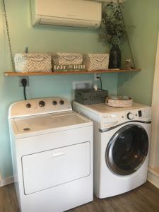 a laundry room with a washer and a dryer at Historic 1850 Log Cabin in Westminster