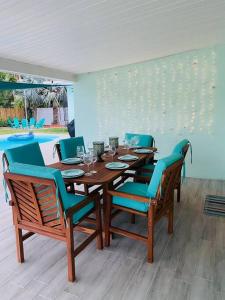 a dining room with a wooden table and chairs at Island Vibes Beach House & 10 min walk to beach in Fort Pierce