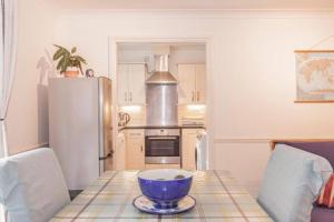 a kitchen with a table with a bowl on it at Oxford City Centre Apartment with parking in Oxford