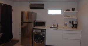 a kitchen with a stainless steel refrigerator and a microwave at Silva Domus in West Orange