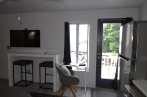een woonkamer met een koelkast en een tafel en stoelen bij Silva Domus in West Orange