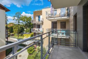 an apartment balcony with a view of a courtyard at Seaside Sopot Apartment with Parking and Gym by Renters in Sopot