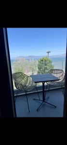 a table and chairs on a balcony with a view at Apartment sea view in Chalkida