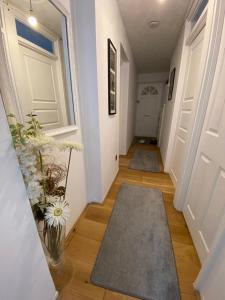 a hallway with white doors and a vase of flowers at 1 Bedroom property in East London in London