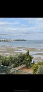 a view of the ocean from a balcony of a beach at Apartment sea view in Chalkida