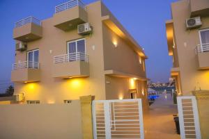 a large house with a fence in front of it at Royal Nile Villas - Nile View Apartment 2 in Luxor