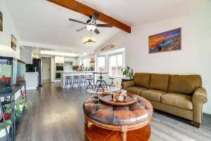 a living room with a couch and a table at Pet-Friendly Reno Hideaway with Private Hot Tub! in Reno