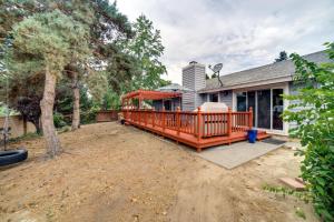 a house with a large deck on a yard at Pet-Friendly Reno Hideaway with Private Hot Tub! in Reno