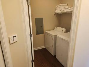 a small laundry room with a washer and dryer at Emma Blue in Collierville