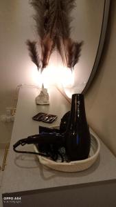 a black bottle sitting on a table in front of a mirror at anoor appartment,just relaxe in Obhor