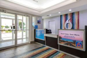 a waiting area with a sign in a dental office at Motel 6-San Antonio, TX - South in San Antonio