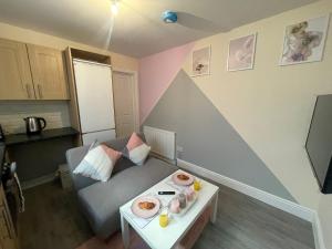 a living room with a couch and a table with food on it at The Oxford Avenue in Southampton