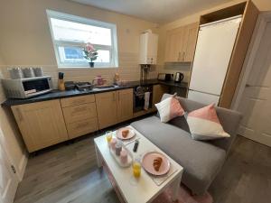 a living room with a couch and a table at The Oxford Avenue in Southampton +29 photos