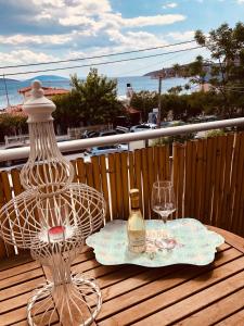 stolik z butelką i dwa kieliszki na balkonie w obiekcie Farniente Tolo w mieście Tolo