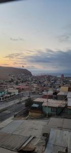 a view of a large city with a hill in the background at Hotel INTI in Arica