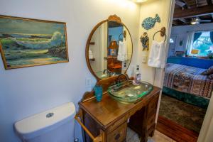 a bathroom with a sink and a mirror at Stella Blue - A in Savannah