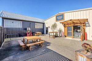 a patio with tables and benches in front of a building at Downtown Digs-Sauna, Hot Tub, Bikes - Fun Times! in Arcata